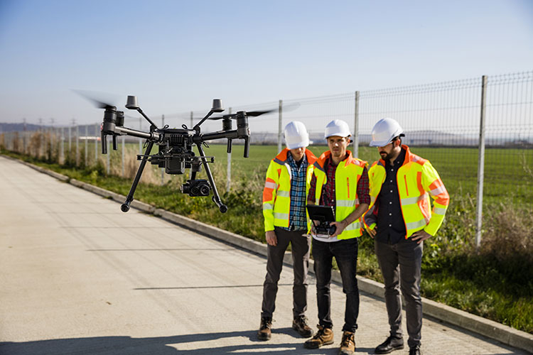 Drone Program - Drone Integration Course - Industry workers flying drone at construction site