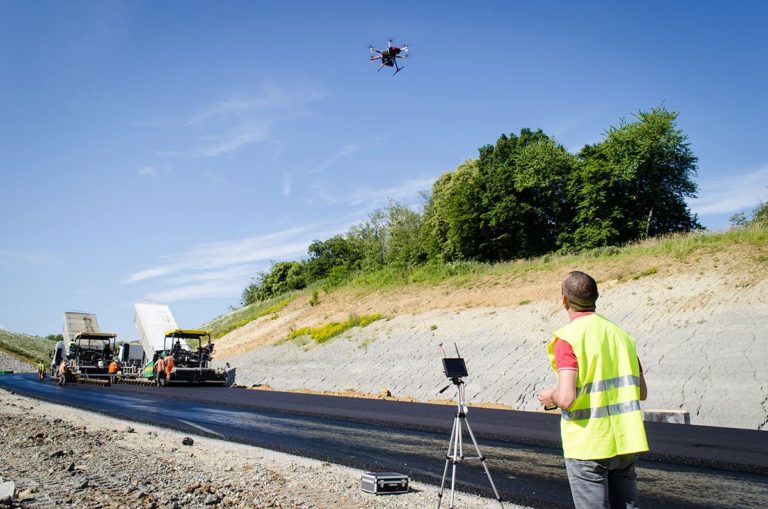 Drones in construction - construction worker using a drone