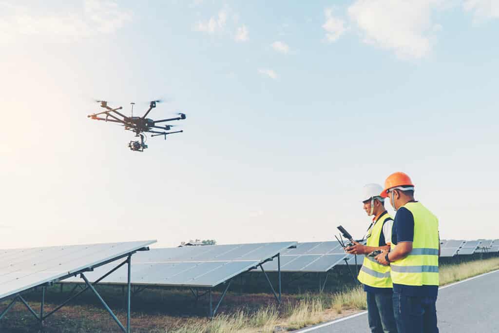 6 industries that are using drones - workers flying drones over solar panels