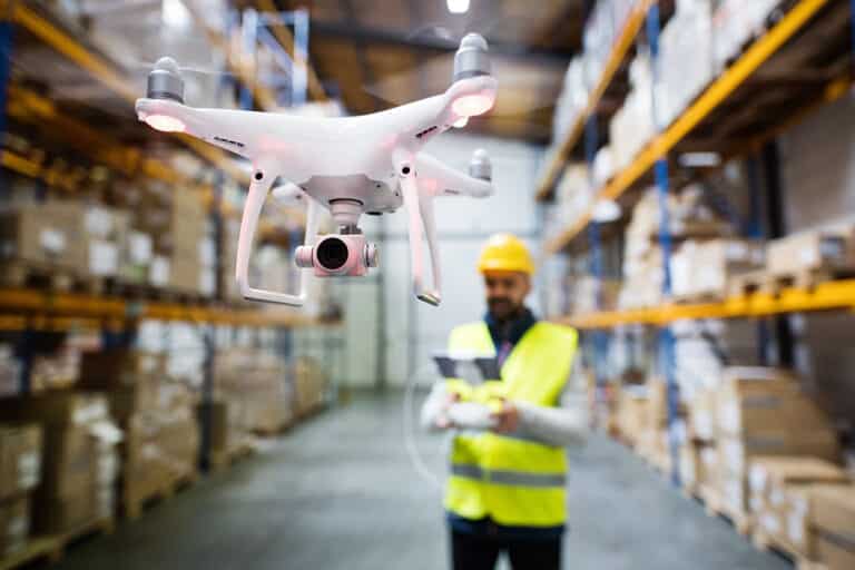 UAS pilot using a drone in a warehouse