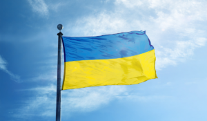 A Ukrainian flag, flying from a flagpole