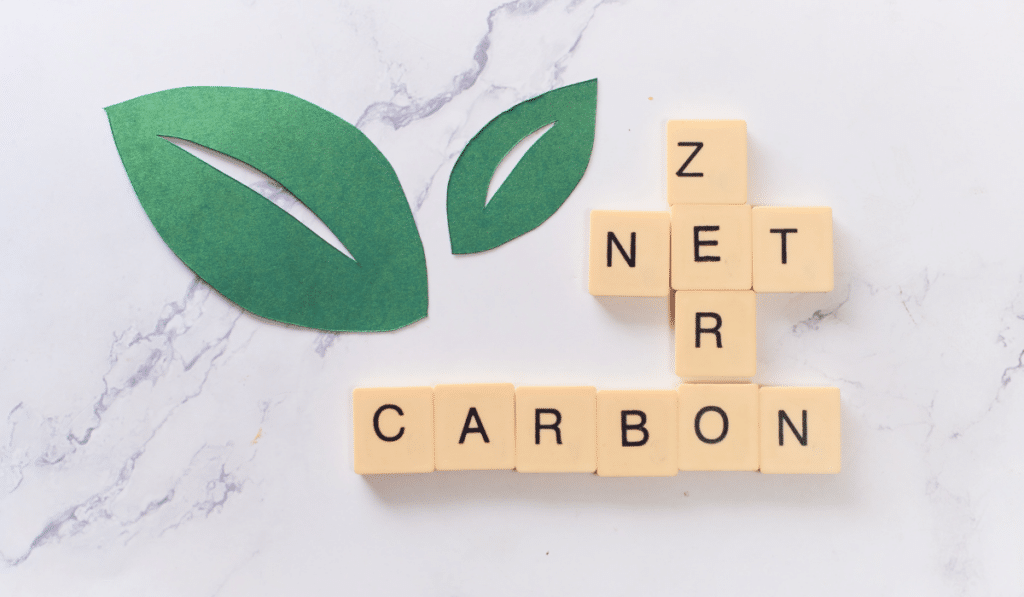 Lettered wooden blocks assembled in a crossword puzzle style. The blocks spell out "Net Zero Carbon", used to describe net-zero emissions